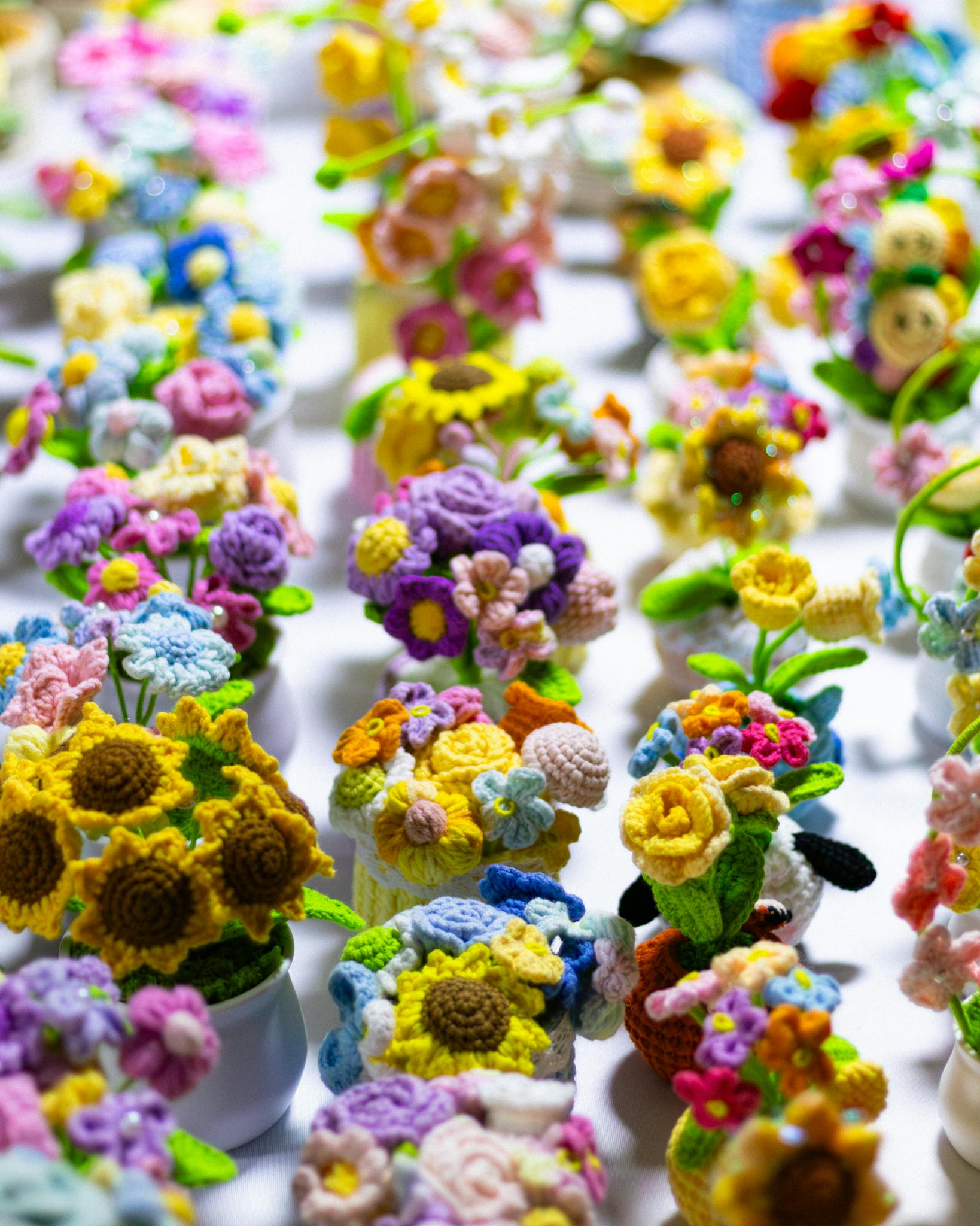 Vibrant crochet flower bouquets in various colors creating a cheerful display.